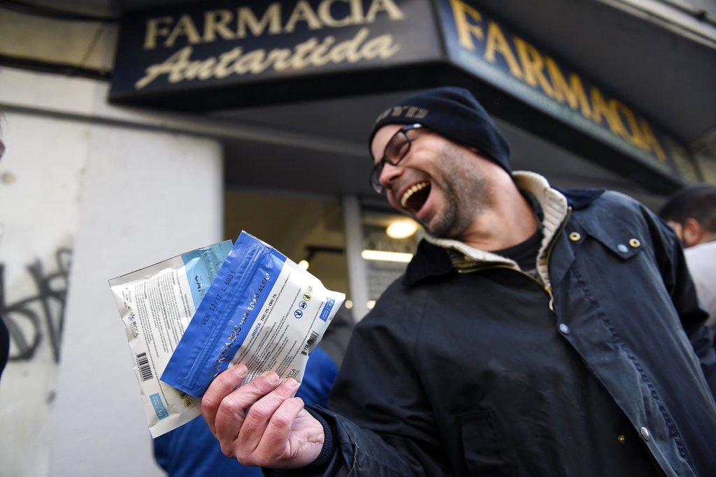 Diego Zas shows two bags of legal marijuana he just bought at the Antartida drugstore in downtown Montevideo, Uruguay, Wednesday, July 19, 2017. Marijuana is going on sale at 16 pharmacies in Uruguay, the final step in applying a 2013 law that made the South American nation the first to legalize a pot market covering the entire chain from plants to purchase. (Matilde Campodonico, The Associated Press)