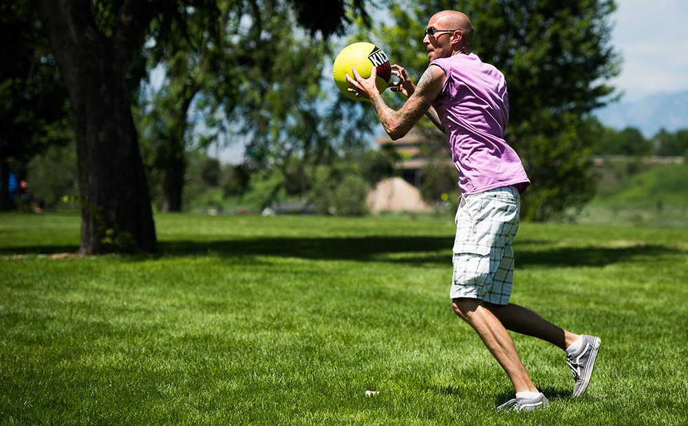 Athletes For Care co-founder Ryan Kingsbury catches the ball during a kickball game at Denver's 420 games on July 22, 2017 in Denver, Colorado. (Gabriel Scarlett, The Denver Post) 